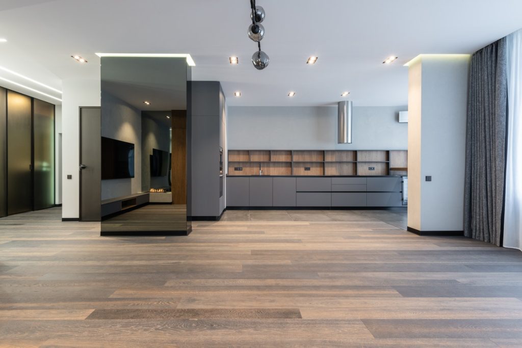 Interior of spacious apartment with grey kitchen furniture