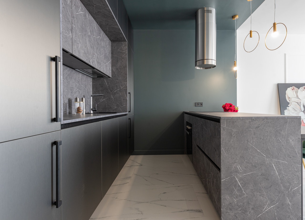 Interior of modern kitchen with gray furniture