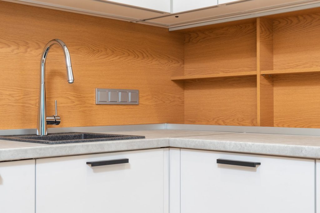 Cabinet with tap above sink in contemporary kitchen